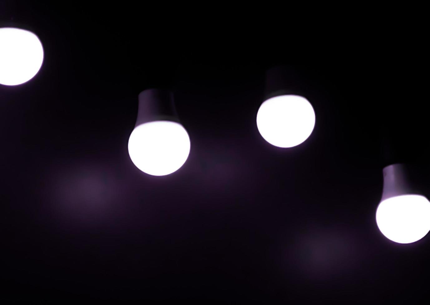 Open Light bulb on black background.add purple color photo