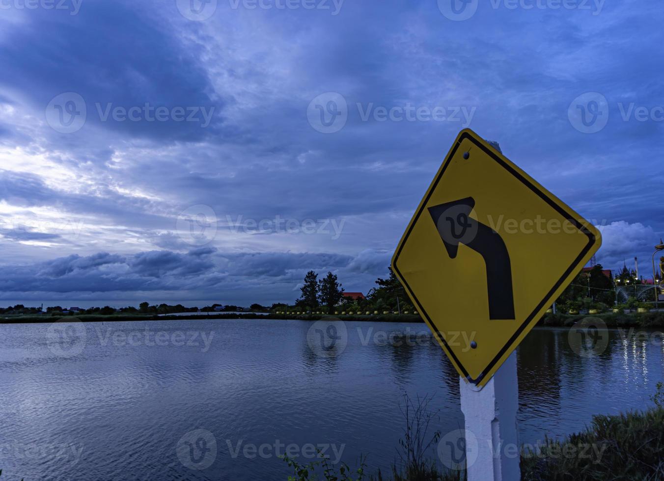 The signs on the left curve point towards the clouds. The sky after the sunset photo