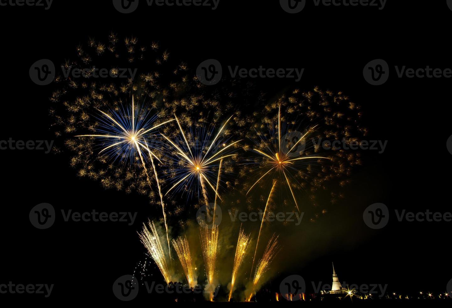 Huge, colorful fireworks over the rice fields at dusk. photo