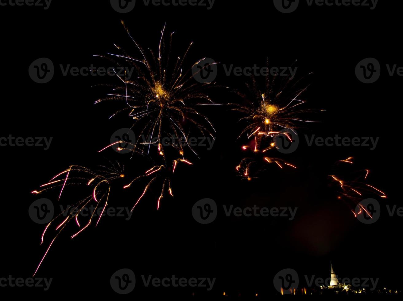 Huge, colorful fireworks over the rice fields at dusk. photo