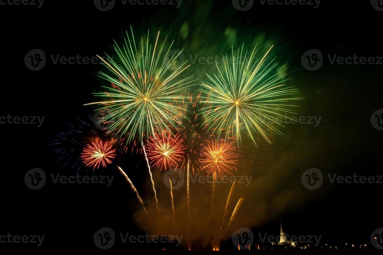Huge, colorful fireworks over the rice fields at dusk. photo