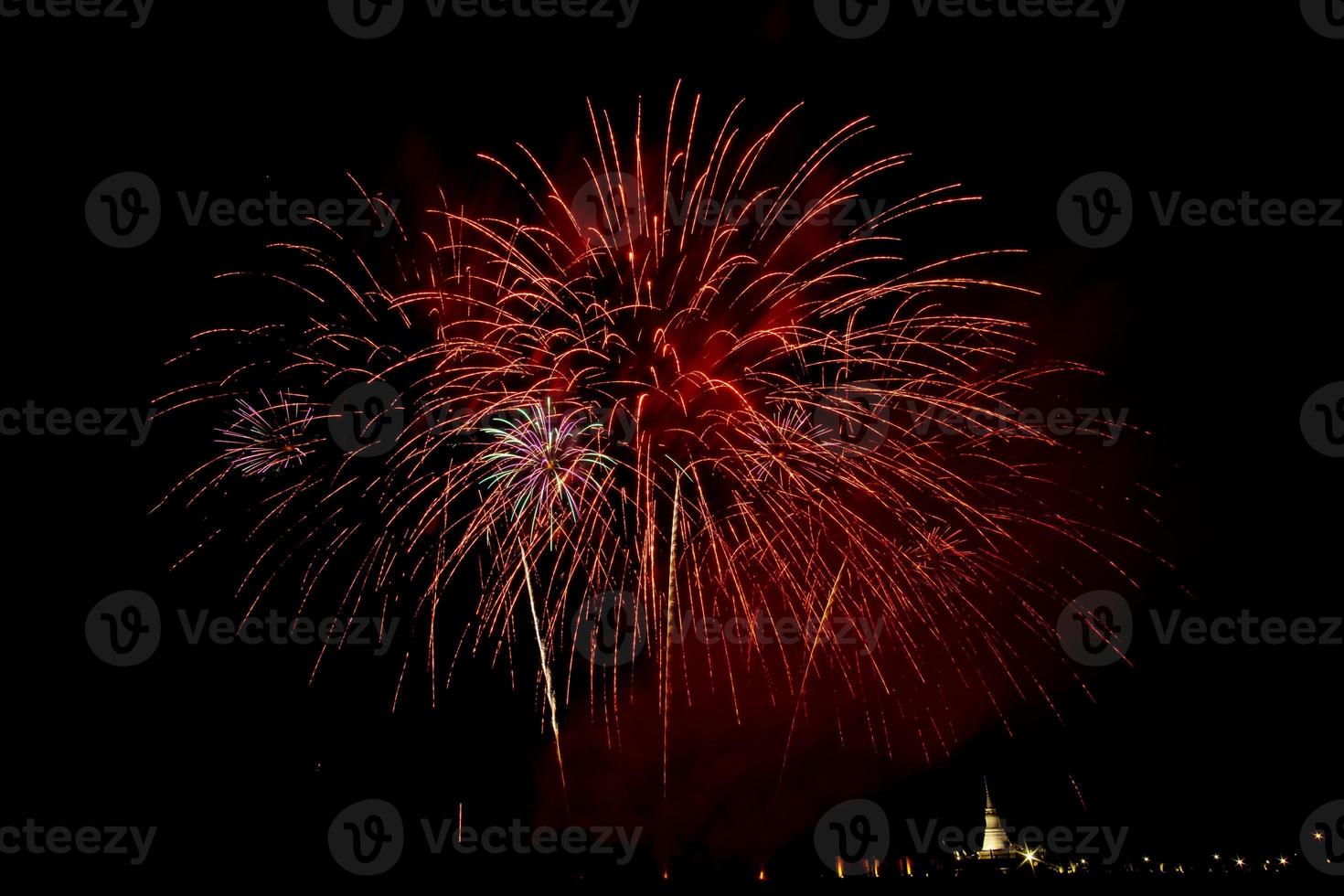 Huge, colorful fireworks over the rice fields at dusk. photo