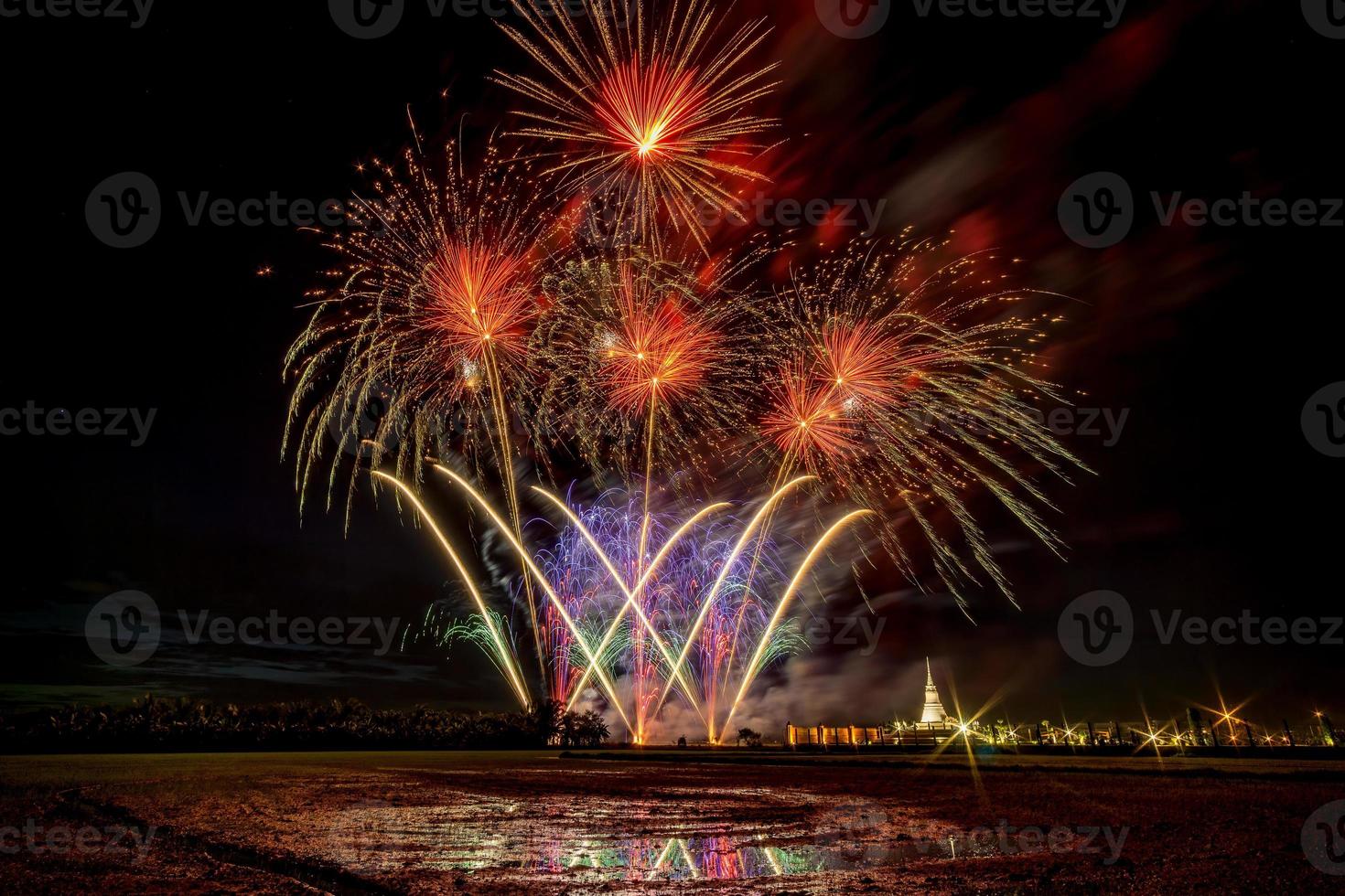 Huge, colorful fireworks over the rice fields at dusk. photo