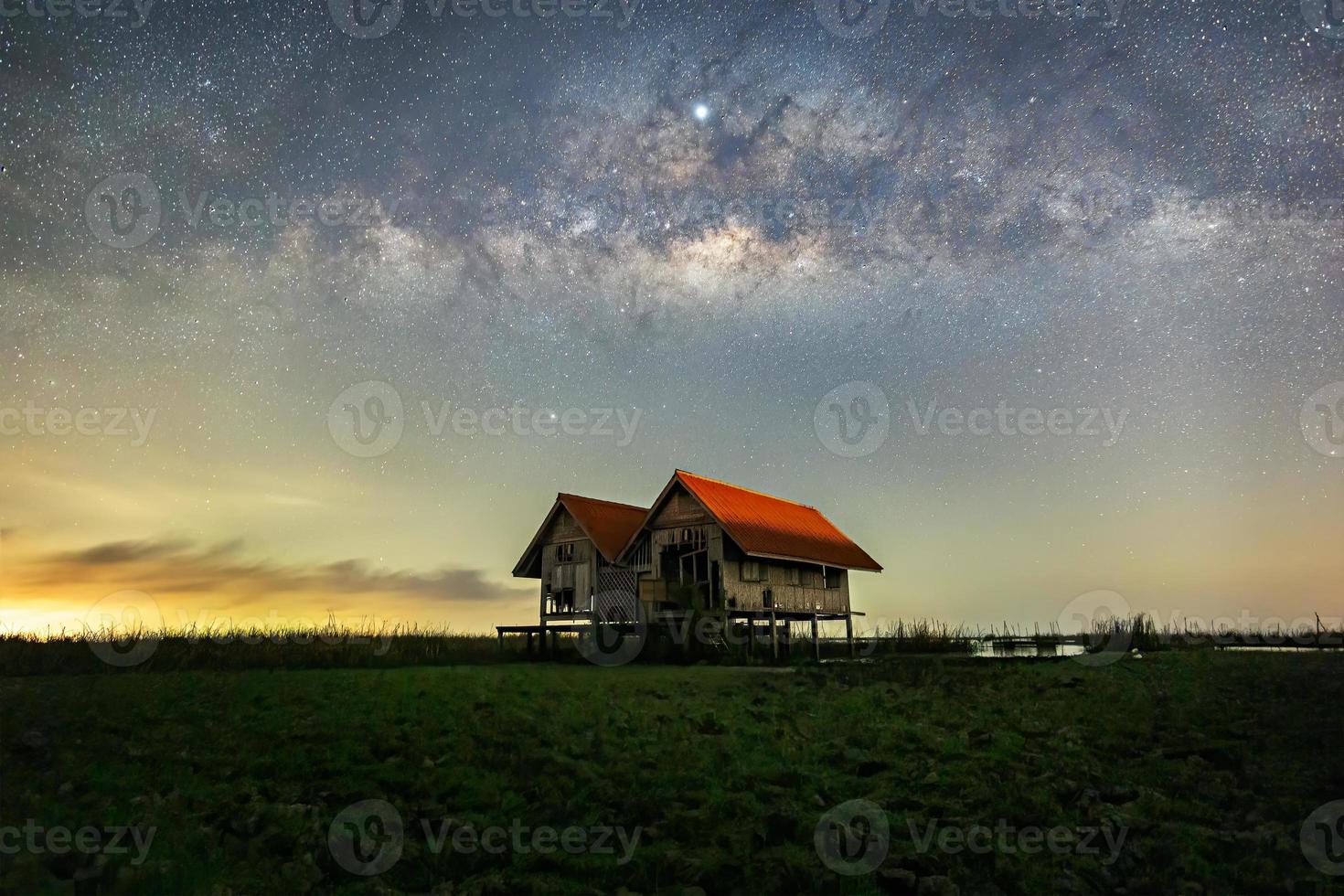 Milky Way , old abandoned house, red roof on open field photo