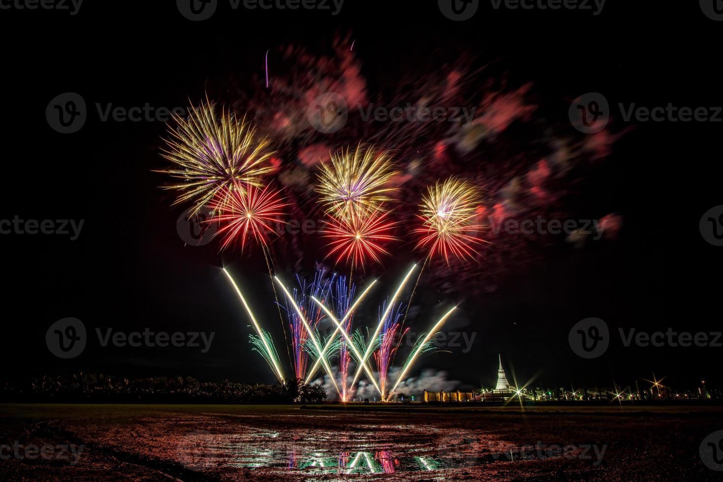 Huge, colorful fireworks over the rice fields at dusk. photo