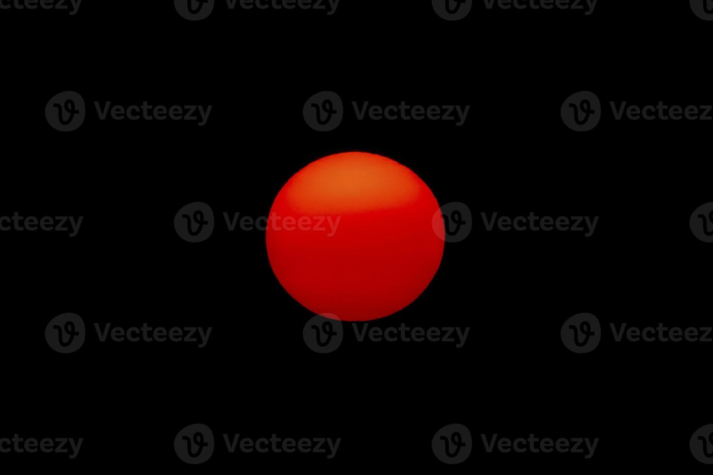 The evening or morning sun can be seen with the naked eye. The sun is red because of the dust and atmosphere. photo