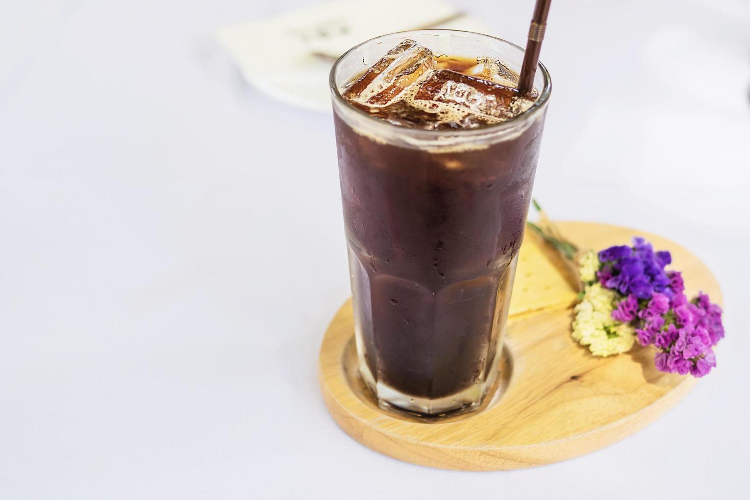 Cold americano glass on white cloth cover table - cold relax beverage concept photo