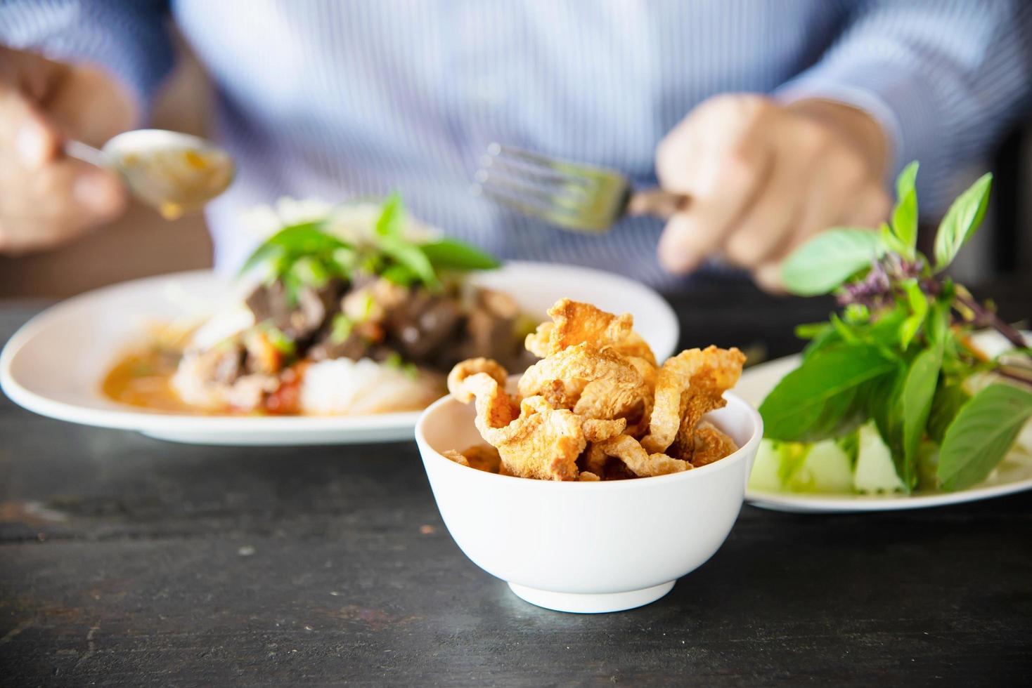 People eating spicy Northern Thai style noodle set - Thai food concept photo