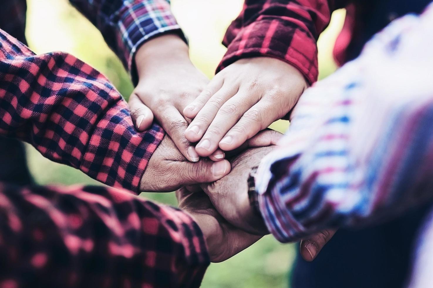 People group join hands together as teamwork unity symbol during their meeting activity to achieve their ultimate goal. photo