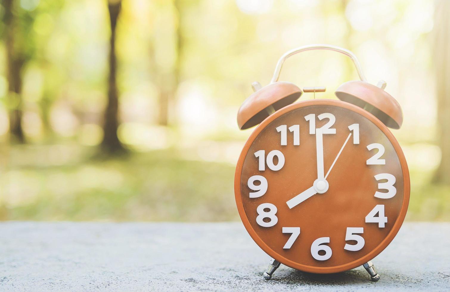 Alarm clock shows eight o clock time in warm morning scene background photo