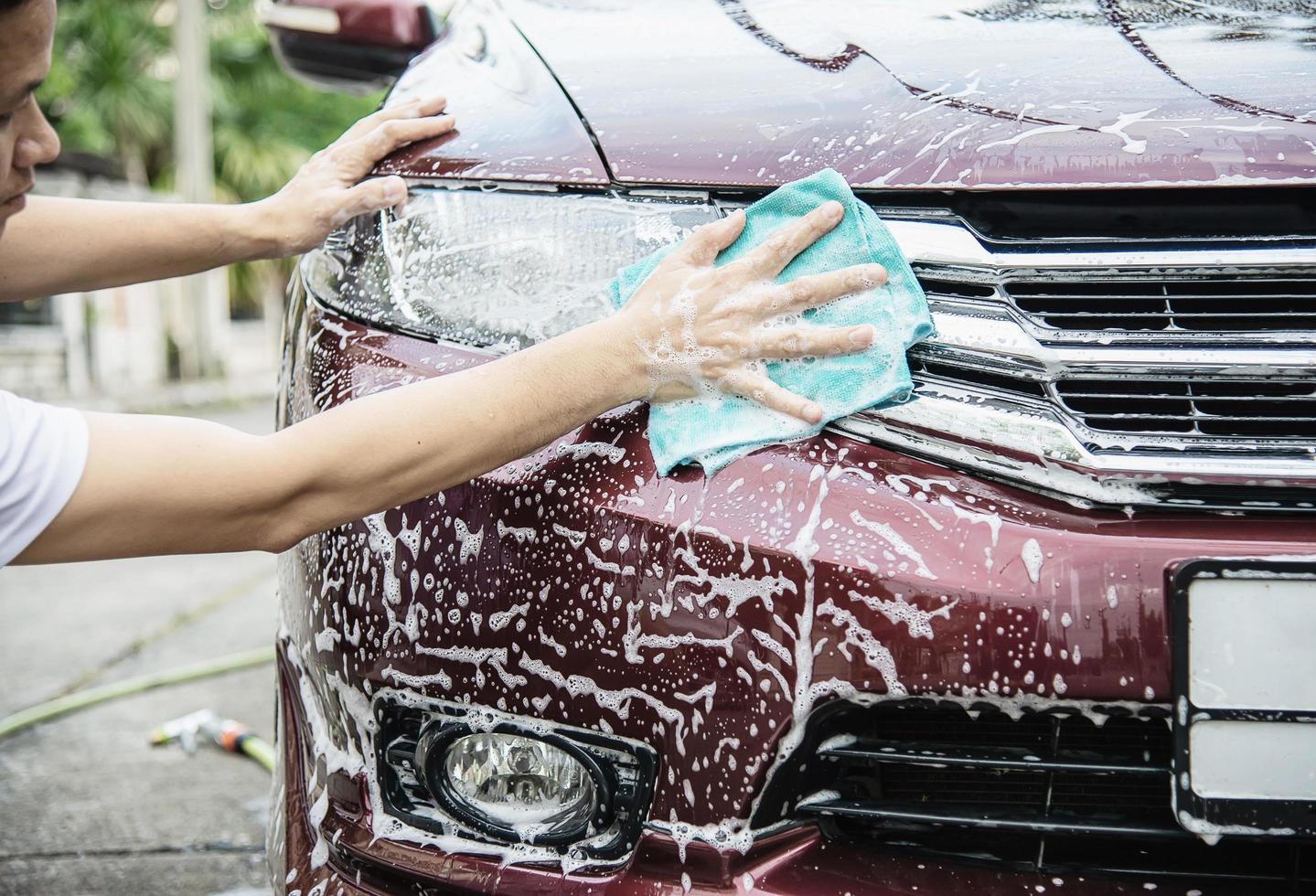 Man wash car using shampoo - every day life car care concept photo