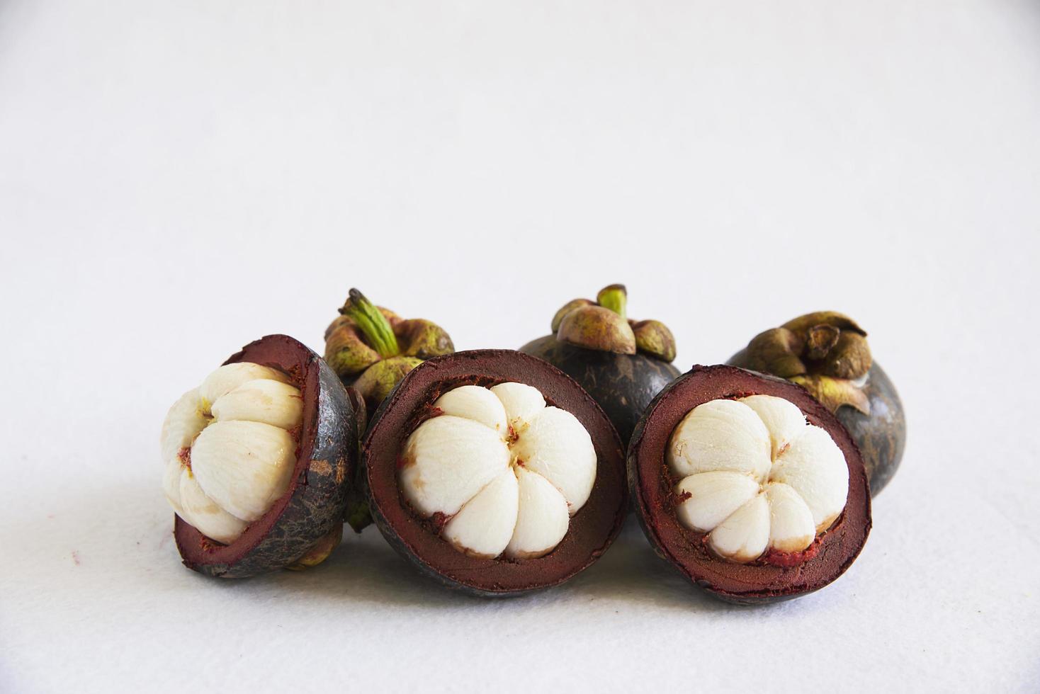 Mangosteen Thai popular fruits - a tropical fruit with sweet juicy white segments of flesh inside a thick reddish-brown rind. photo