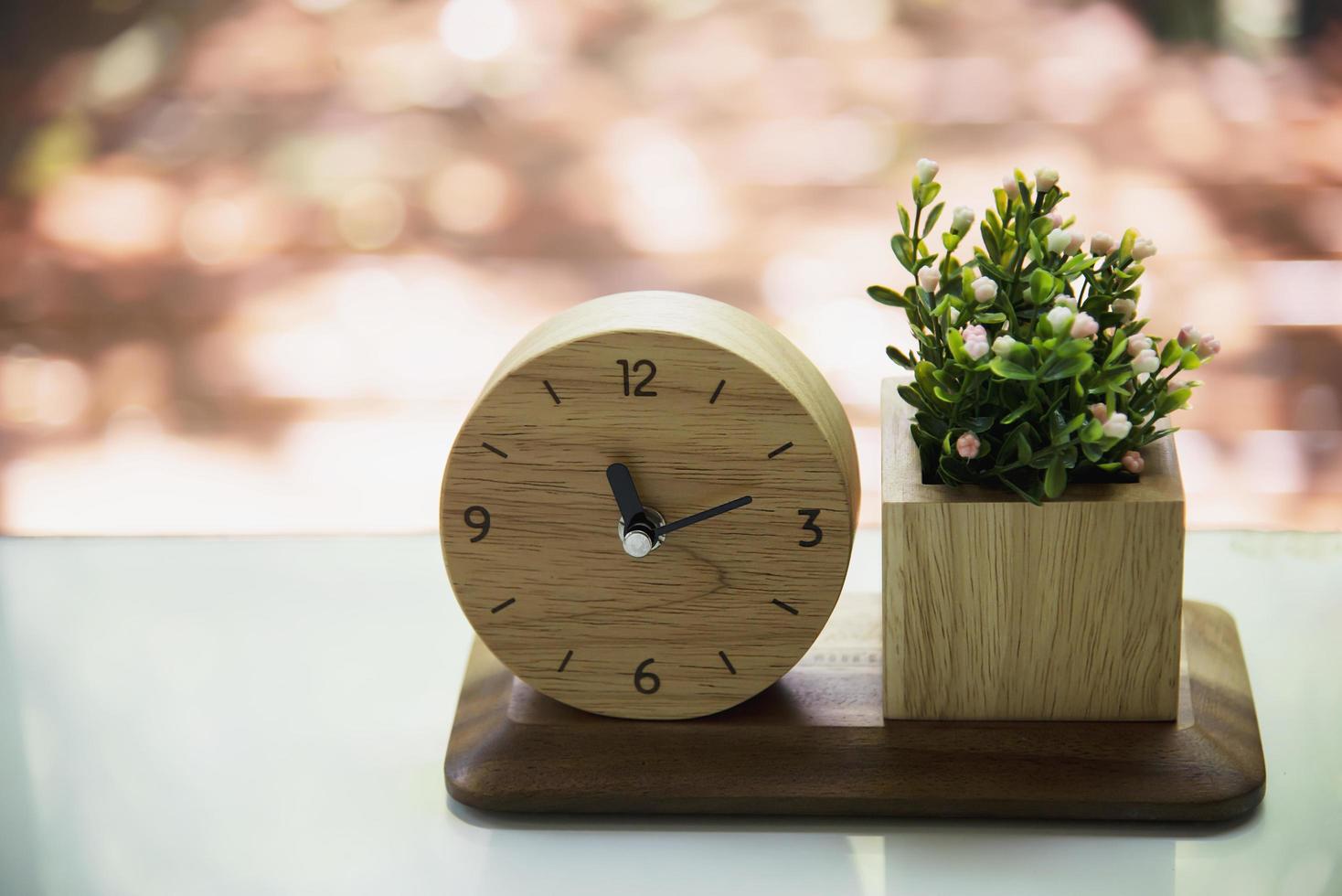 Small wooden clock with decorated flower set - interior home decoration object for background use photo