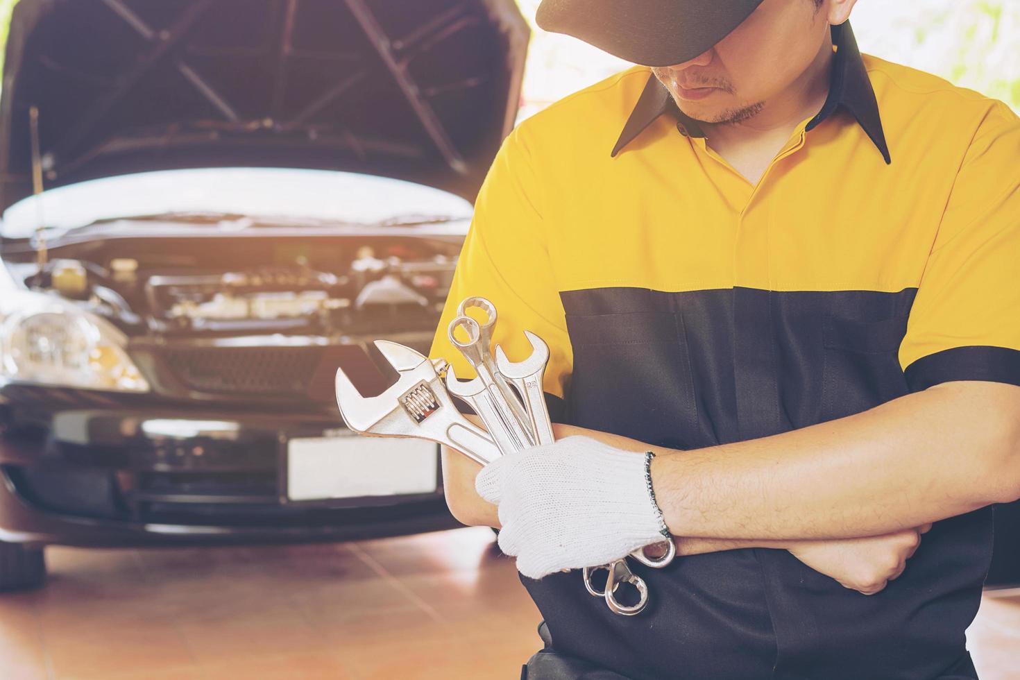 Mechanic man repairing car photo