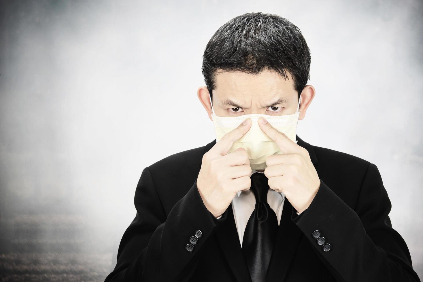 Man wearing mask protect fine dust in air pollution environment - people with protection equipment for air pollution concept photo