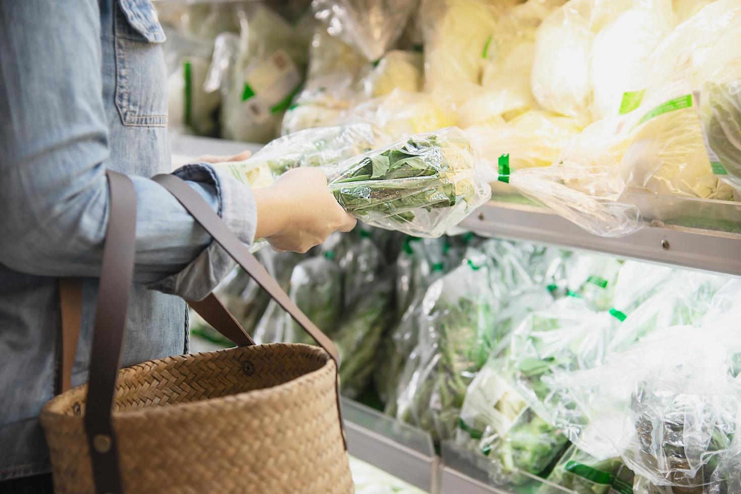 Lady is shopping fresh vegetable in supermarket store - woman in fresh market lifestyle concept photo