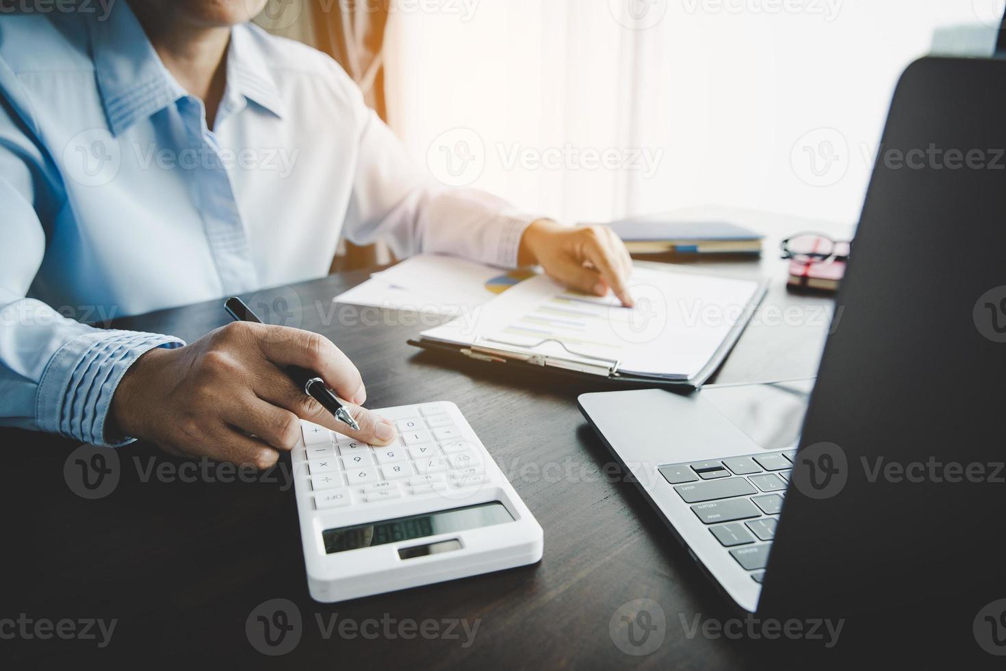 Professional businesswoman working on desk in office. Business woman hand analysis graph document financial on paperwork with chart data and marketing growth report on table. photo