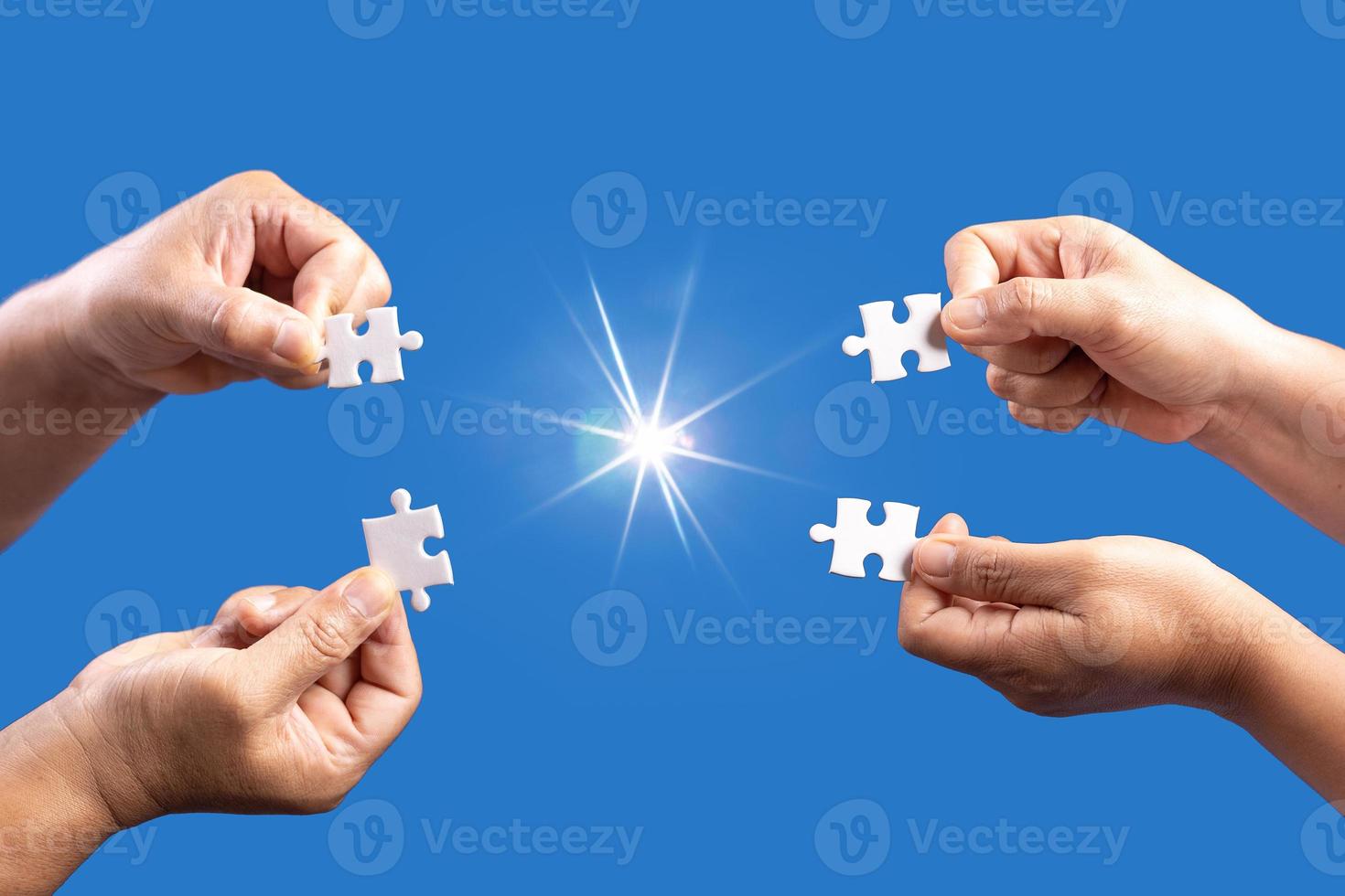 Hands holding jigsaw puzzles piece with clear blue background, success business, solution strategy, teamwork partnership concept photo