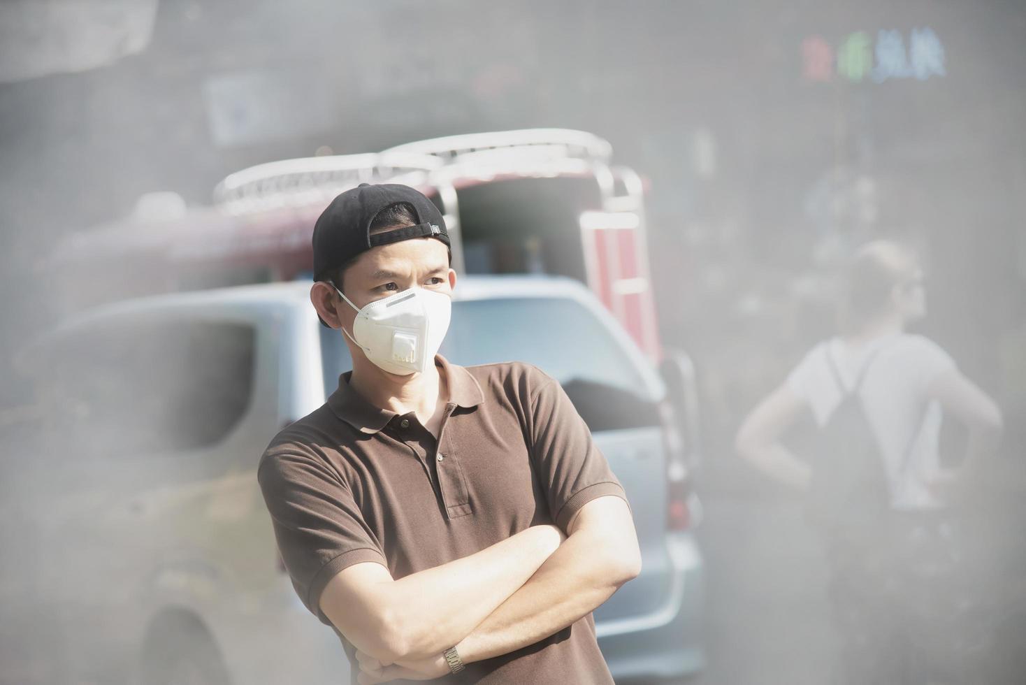 Man wearing mask protect fine dust in air pollution environment - people with protection equipment for air pollution concept photo