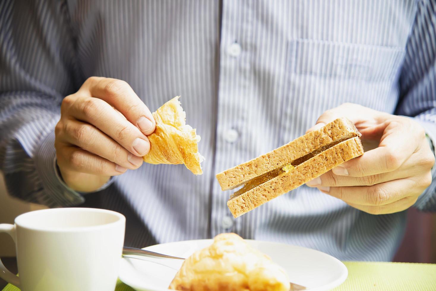 Business man eat the American breakfast set in a hotel - people take a breakfast in hotel concept photo