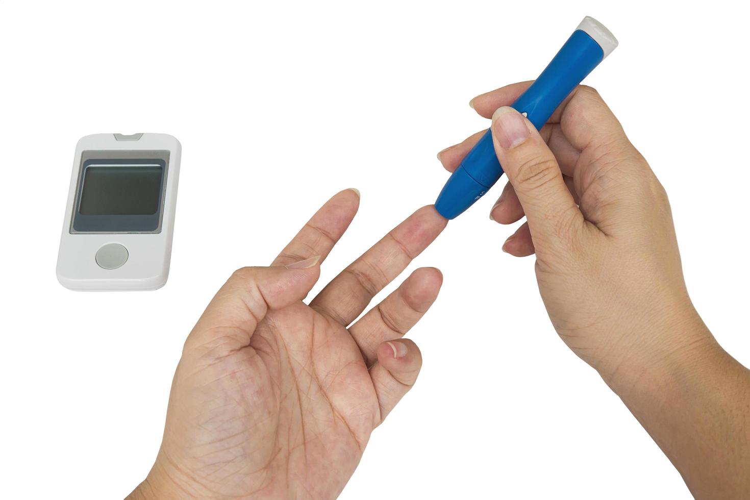 Woman is checking diabetes using blood checking kit isolated over white photo