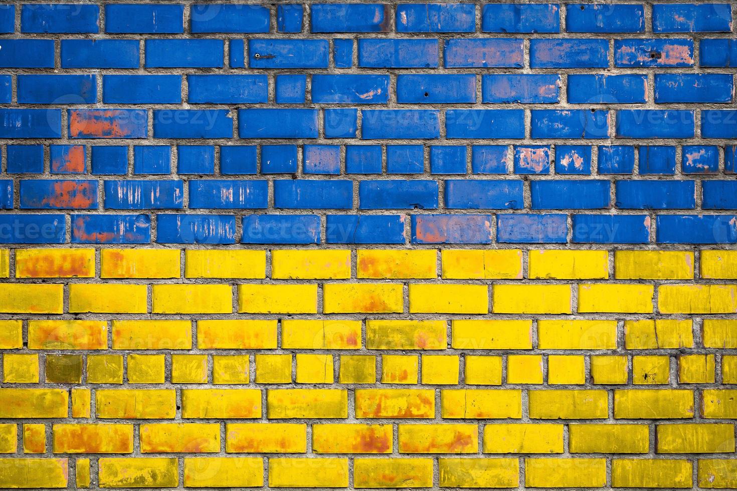 National  flag of the Ukraine on a grunge brick background. photo