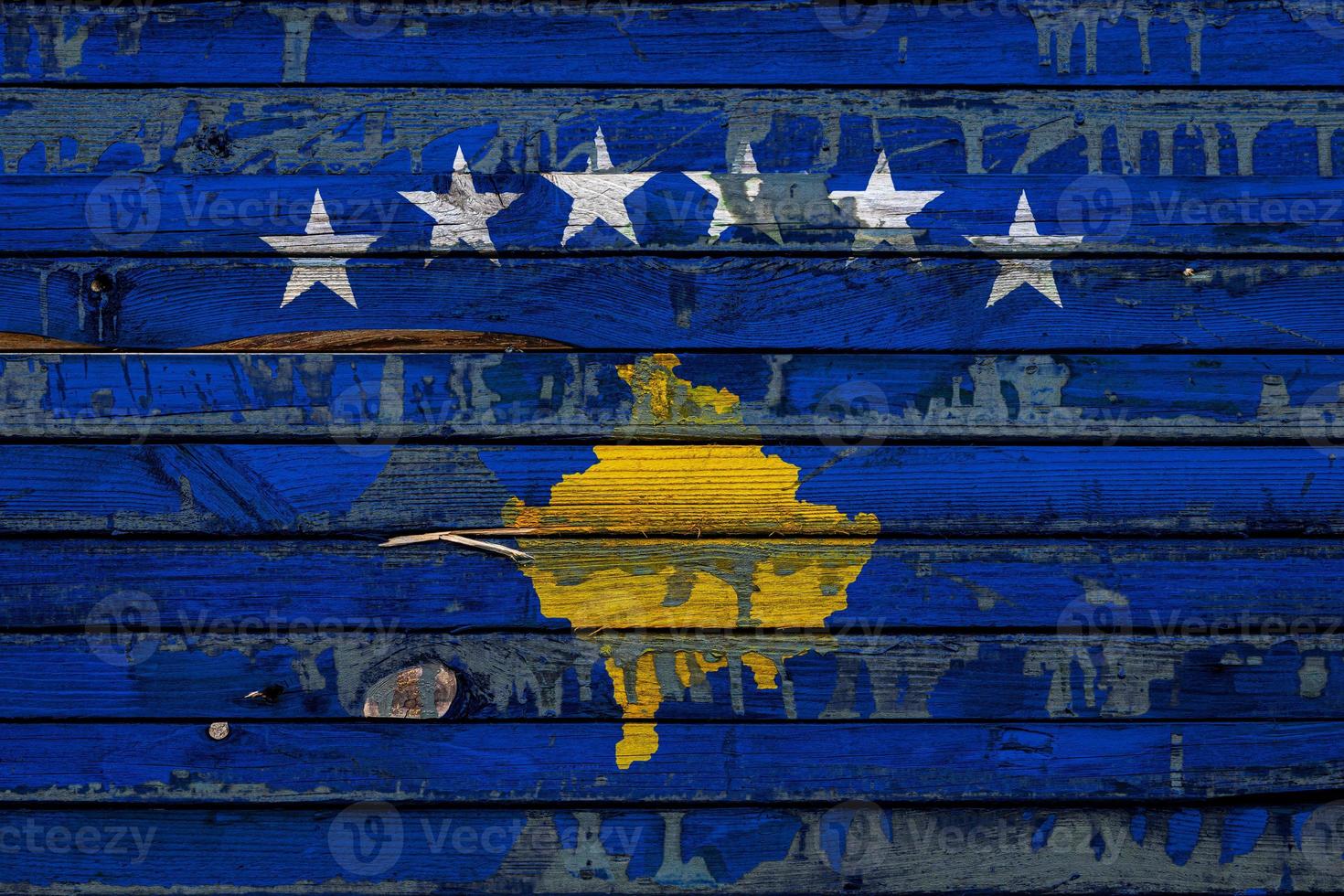 The national flag of Kosovo  is painted on uneven boards. Country symbol. photo