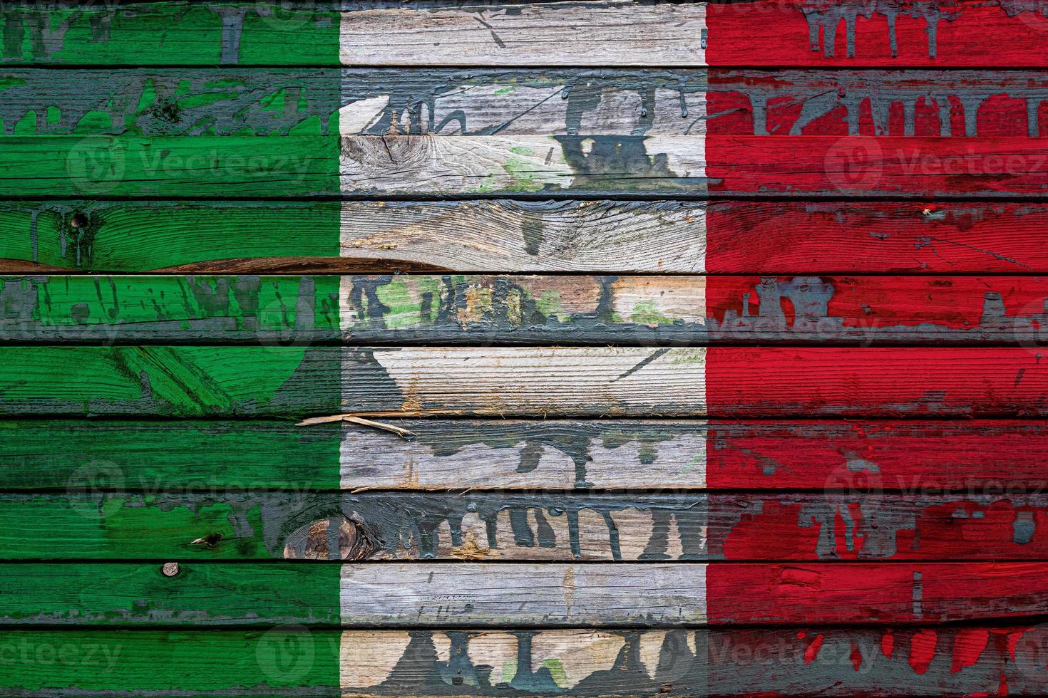 The national flag of Italy is painted on uneven boards. Country symbol. photo