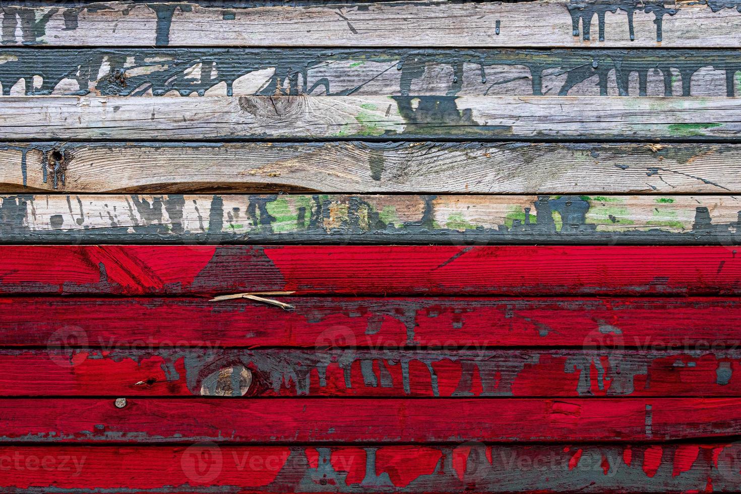 The national flag of Poland  is painted on uneven boards. Country symbol. photo