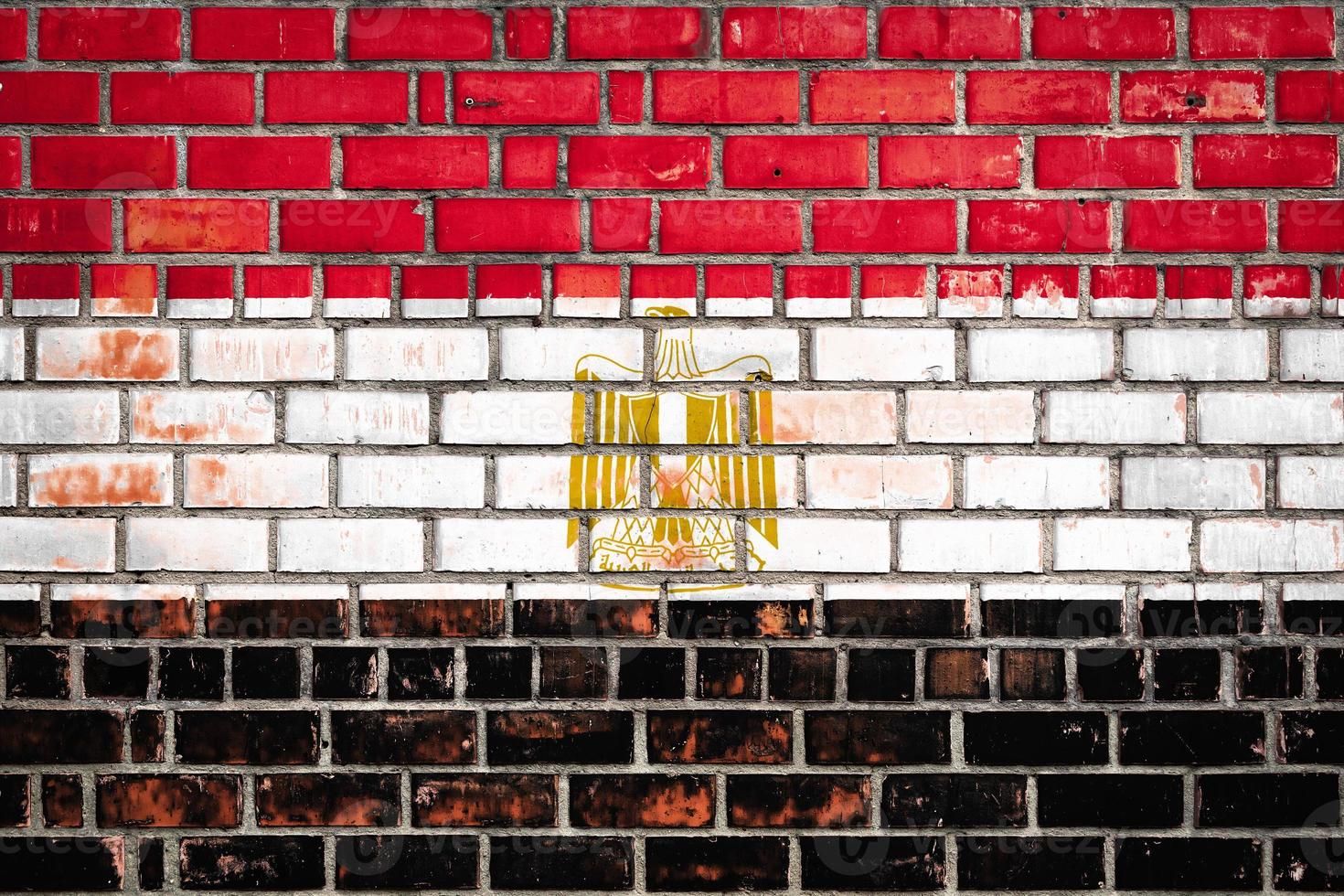 National  flag of the Egypt   on a grunge brick background. photo