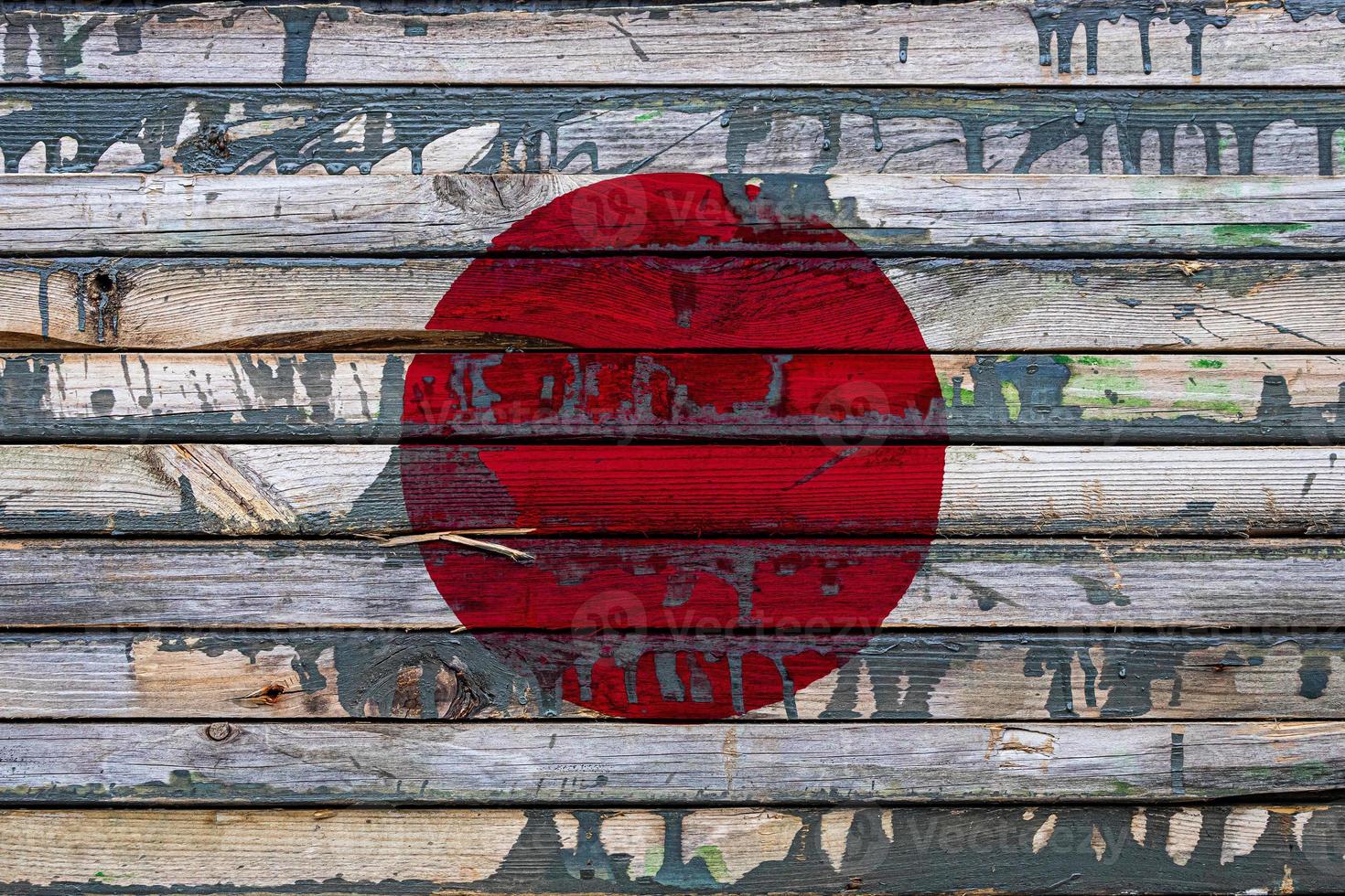 The national flag of Japan is painted on uneven boards. Country symbol. photo