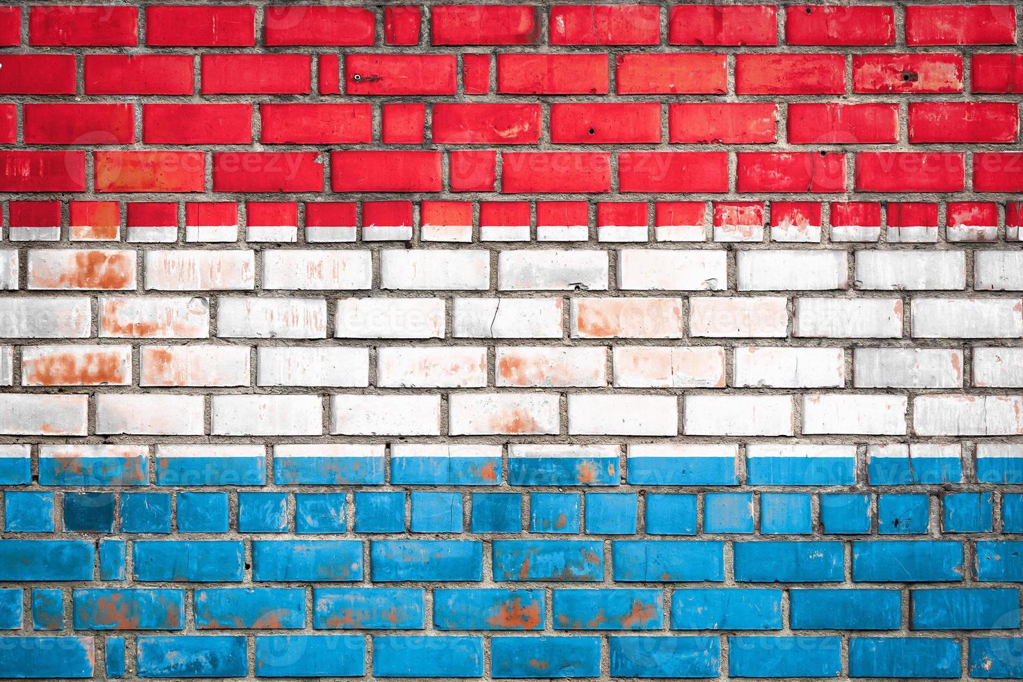National  flag of the   Luxembourg  on a grunge brick background. photo