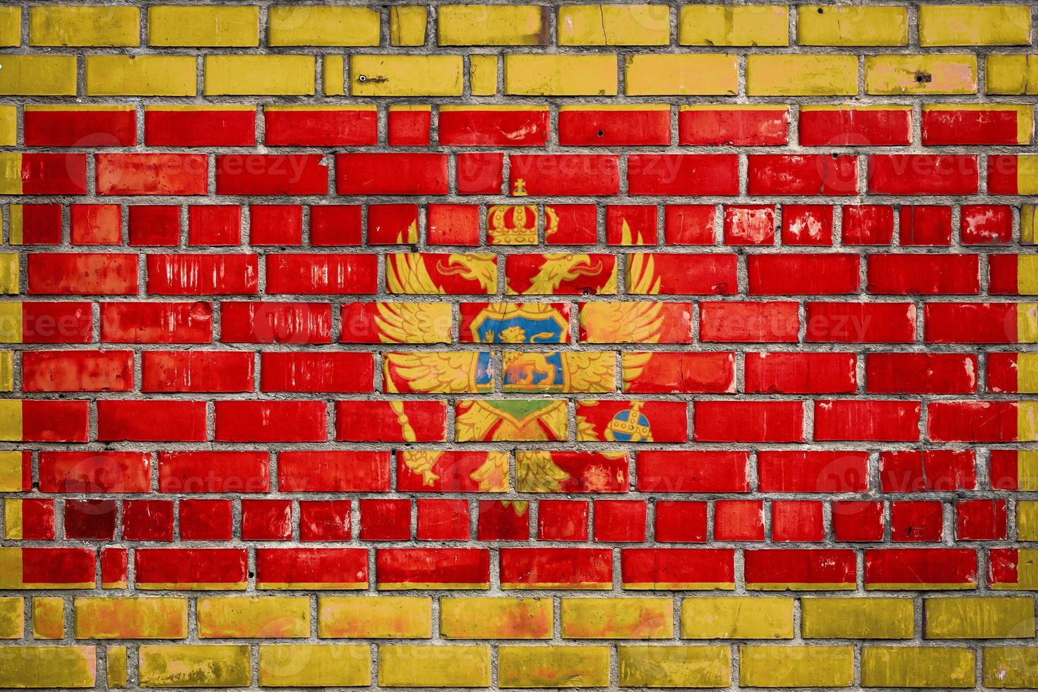 National  flag of the  Montenegro  on a grunge brick background. photo