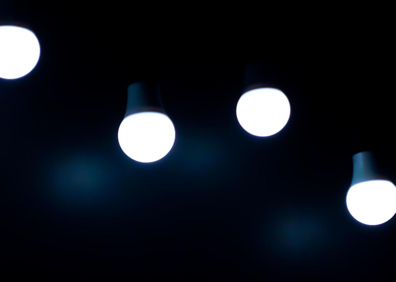 Open Light bulb on black background.add blue color photo