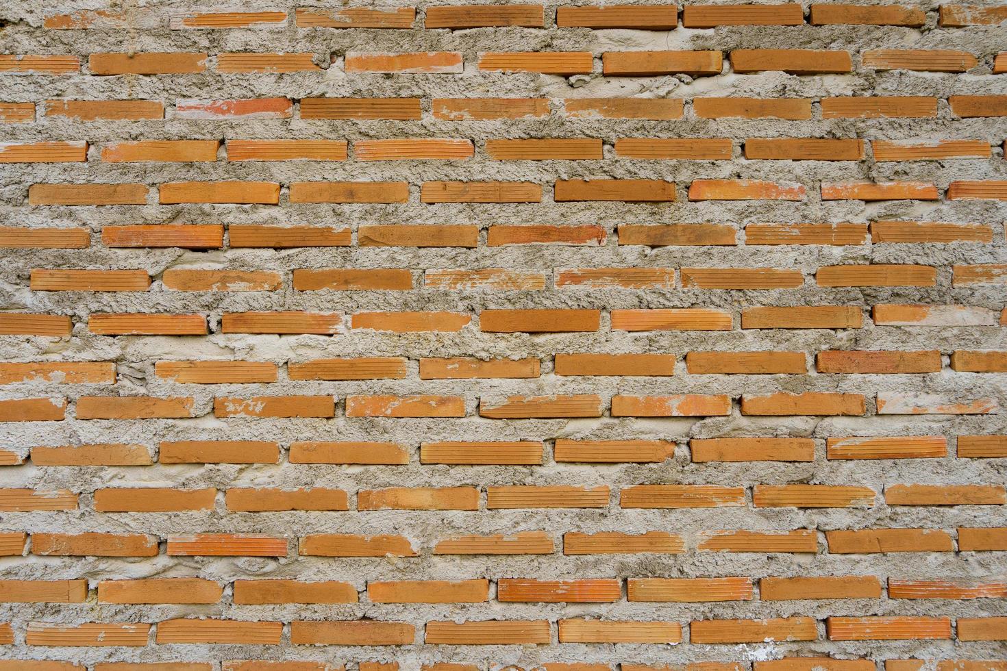 The textured background of the red brick wall is arranged in layers of the construction of the house flap. photo