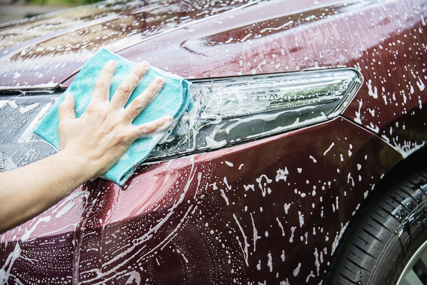 Man wash car using shampoo - every day life car care concept photo