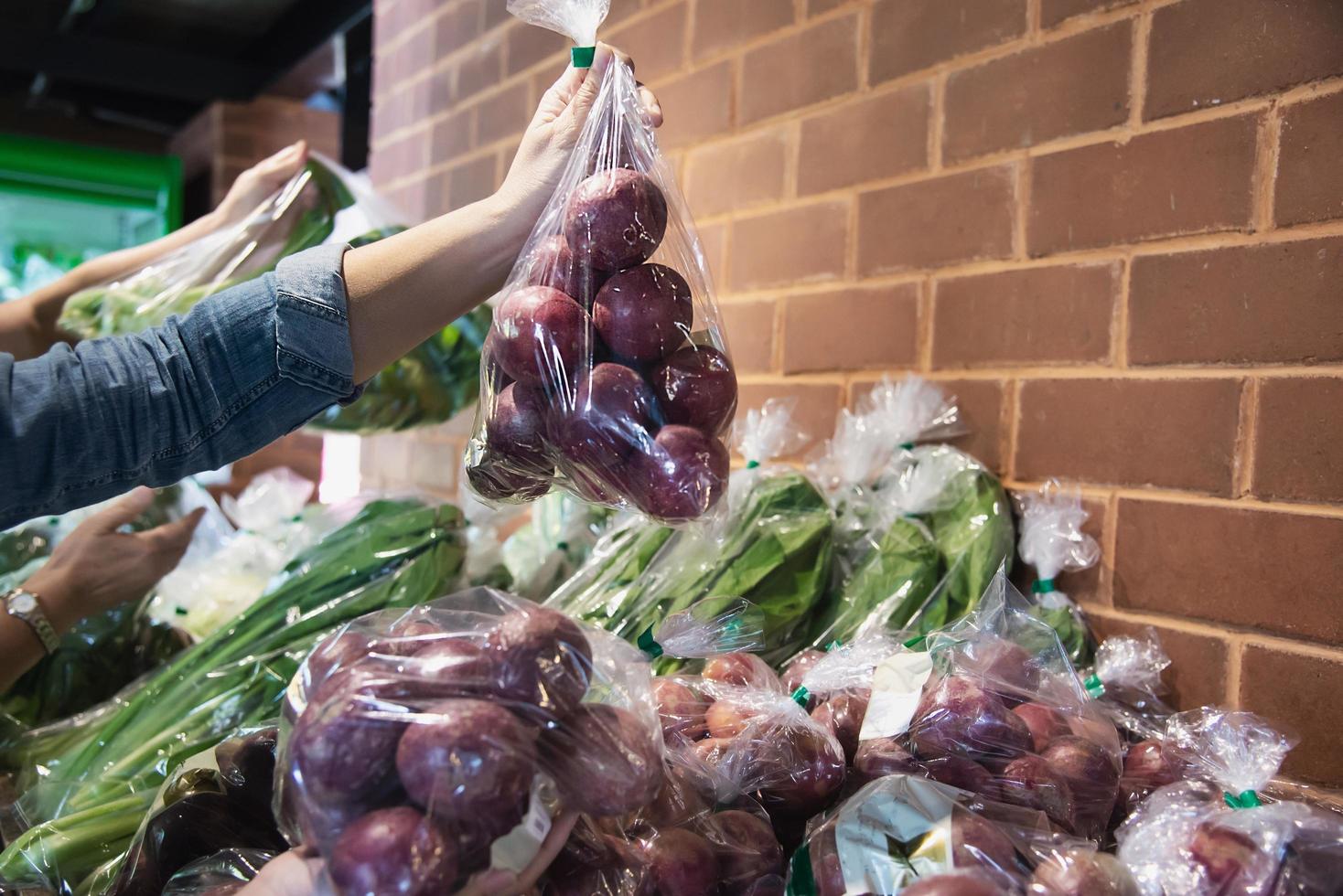 Lady is shopping fresh vegetable in supermarket store - woman in fresh market lifestyle concept photo