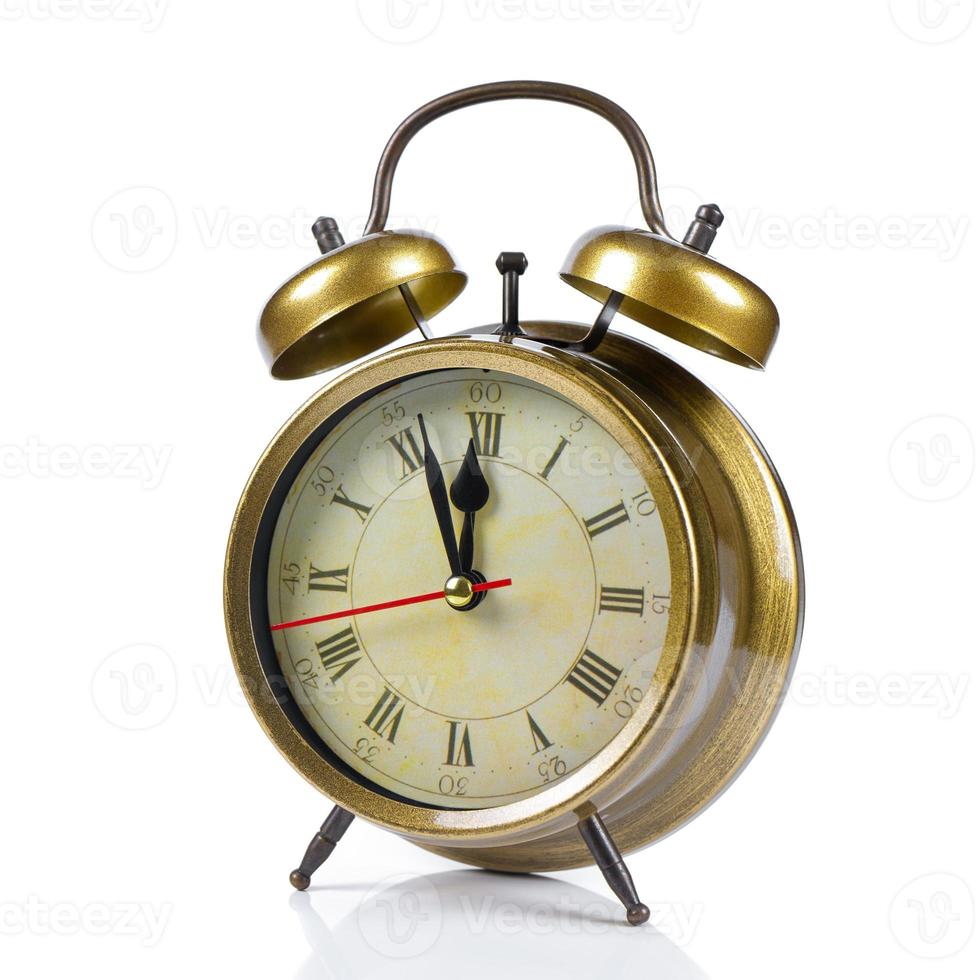 bronze vintage alarm clock isolated on white background photo