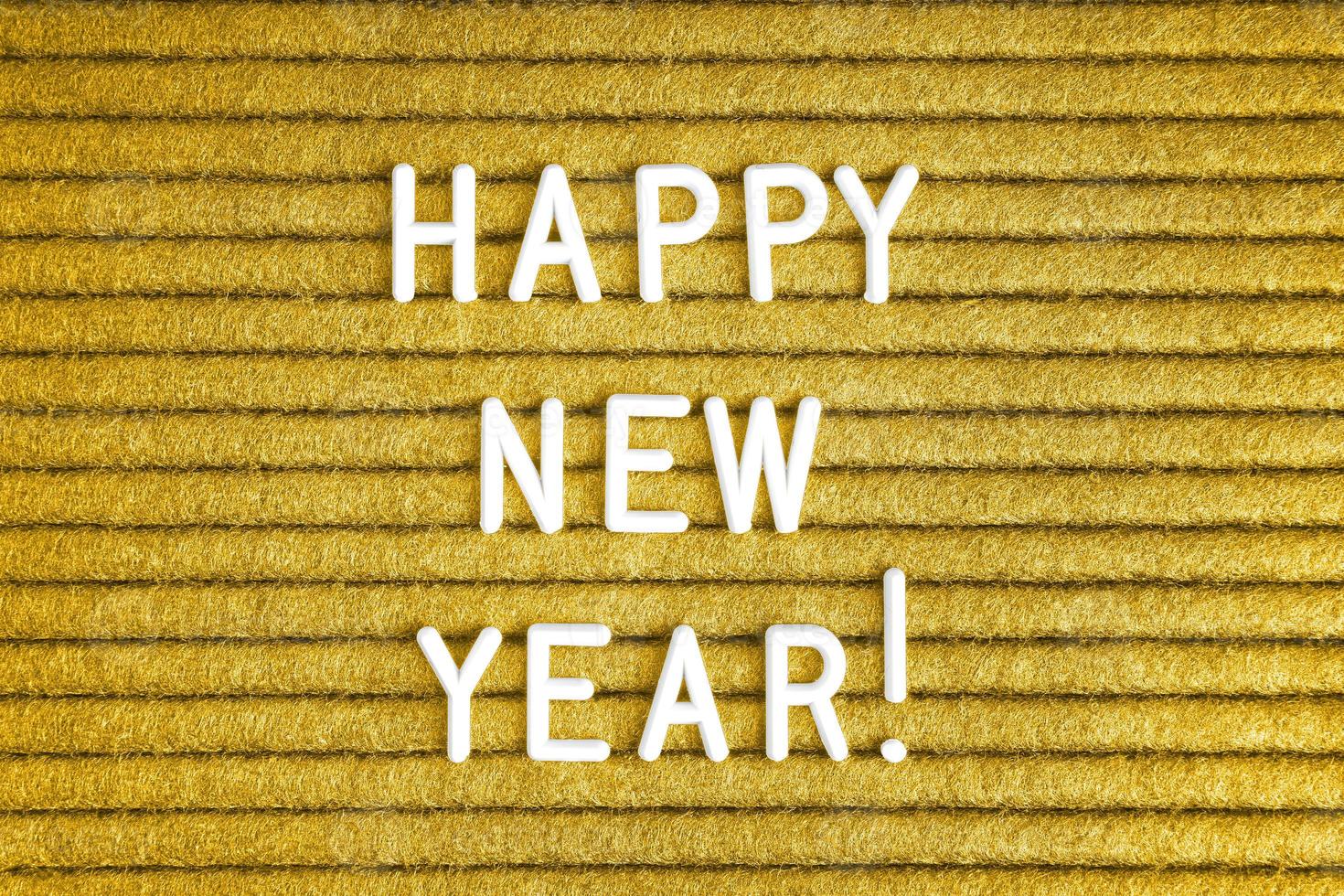 Happy new year , text on yellow felt letter board with white letters photo