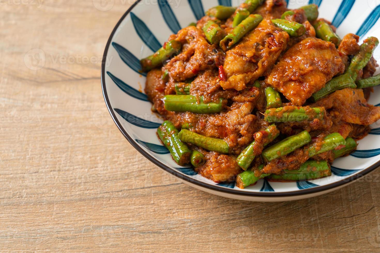 Stir fried pork with red curry paste photo