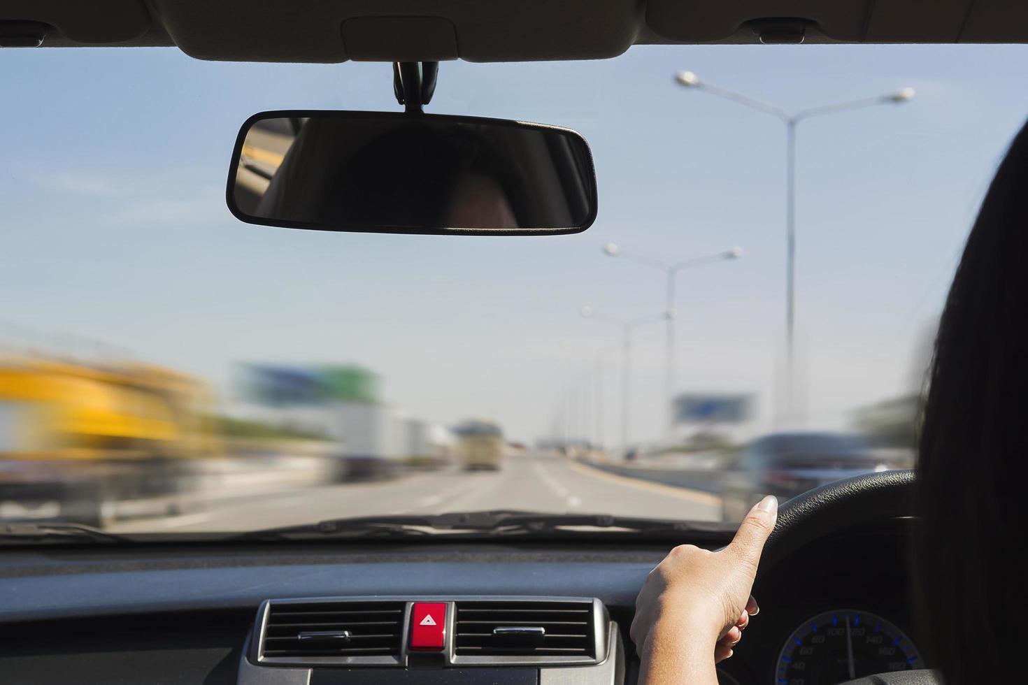 Woman driving car using two hand photo