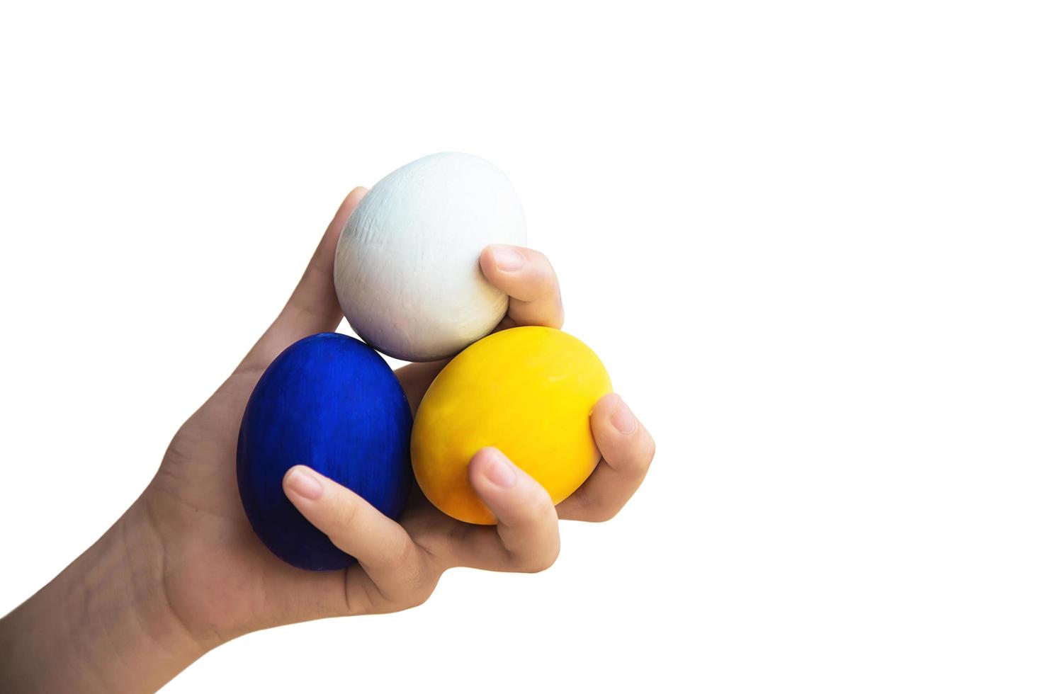 Child showing colorful Easter eggs happily - Easter holiday celebration concept photo