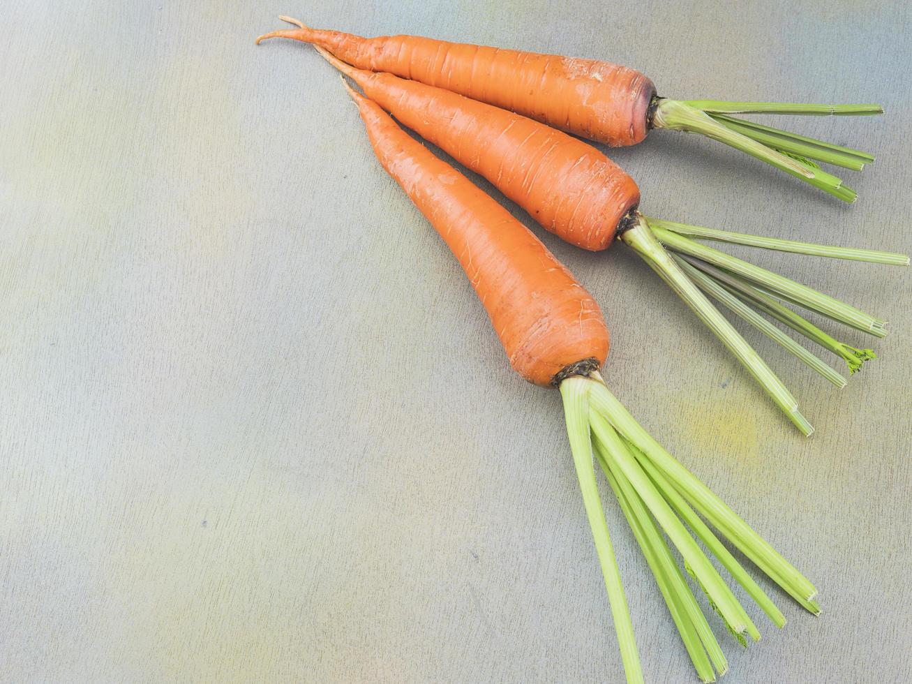 Fresh carrot on wooden table photo