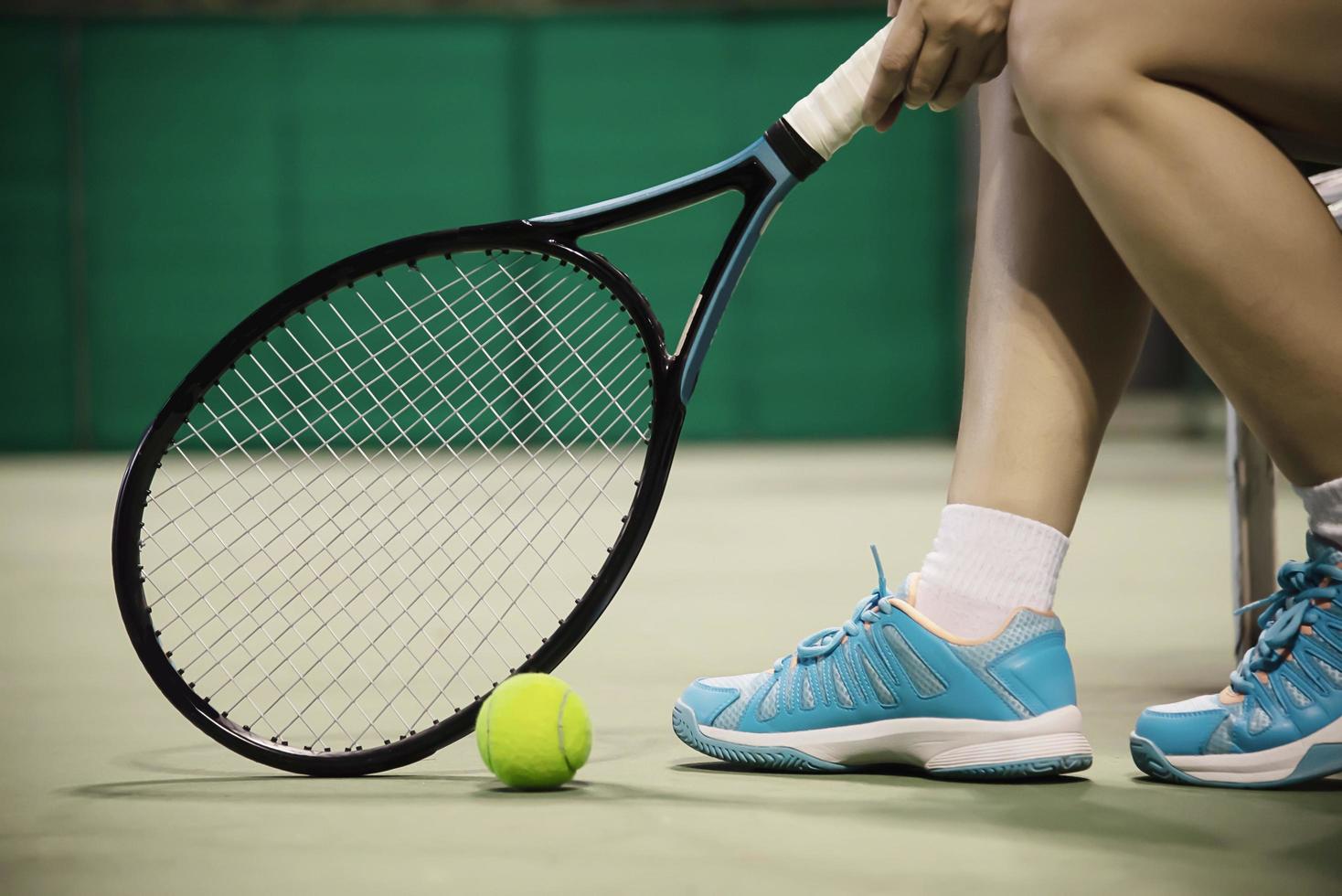 Lady tennis player sitting in the court during game break - people in sport tennis game concept photo
