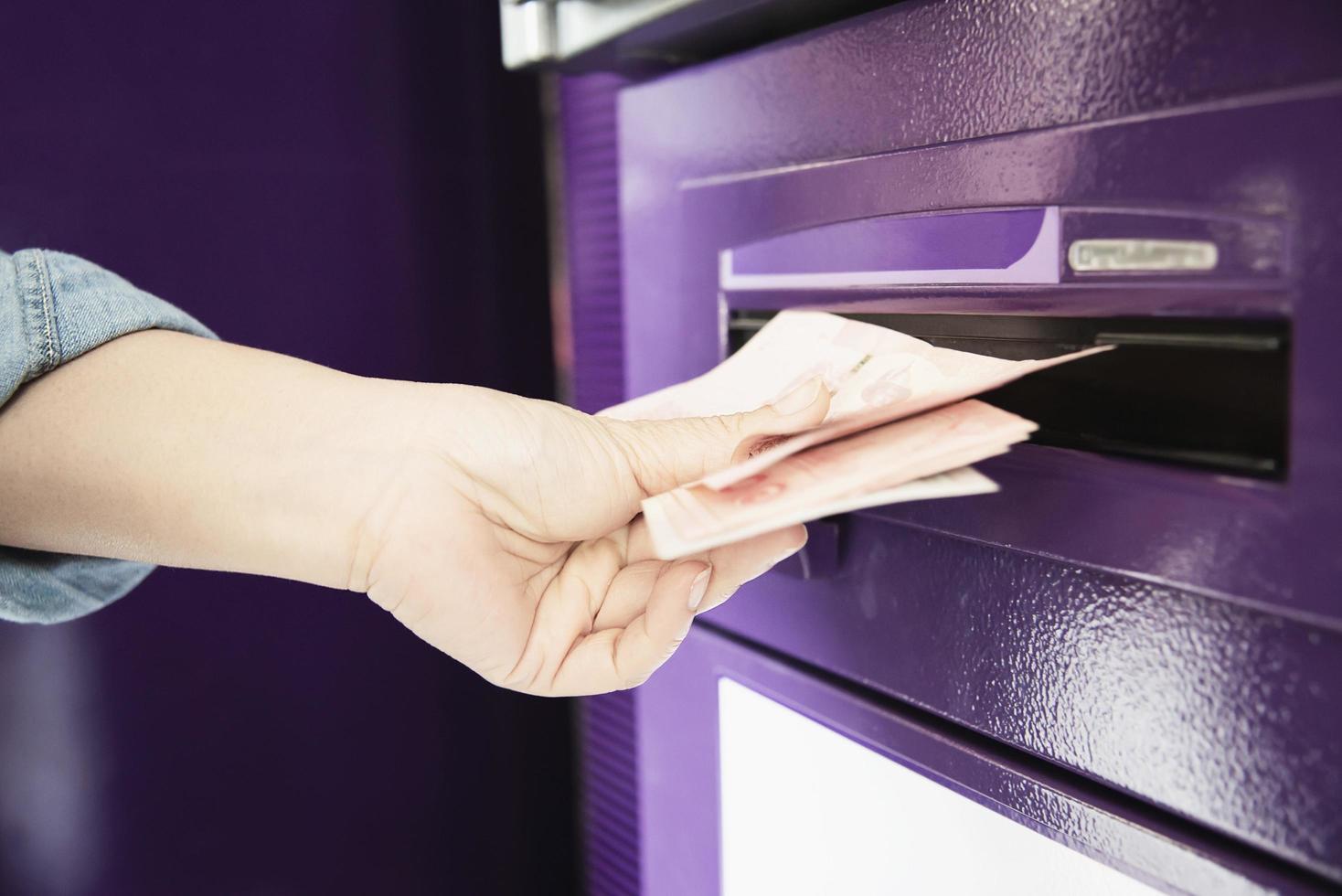 People waiting to get money from automated teller machine - people withdrawn money from ATM concept photo