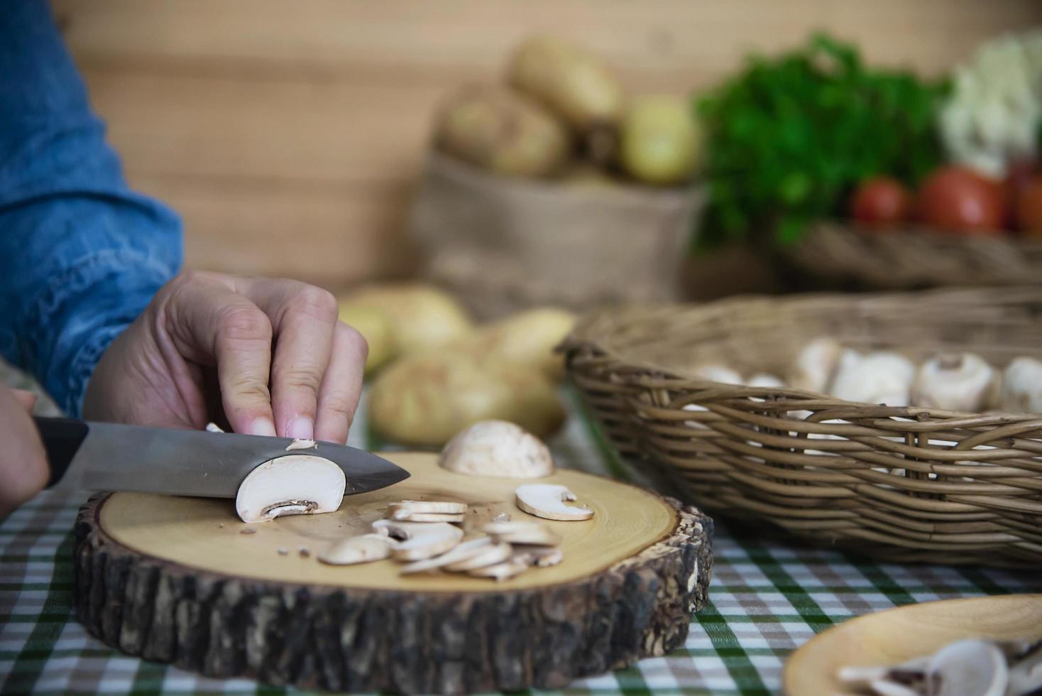 señora cocina champiñón fresco vegetal en la cocina - personas con concepto de cocina vegetal foto