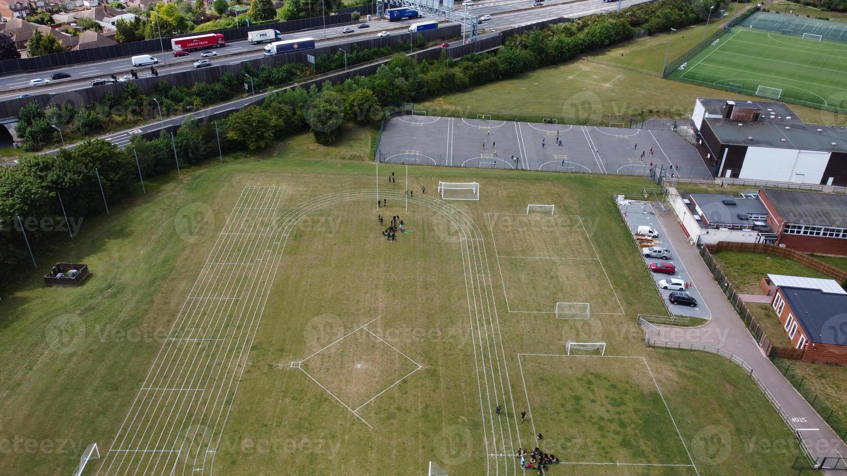 An Aerial Footage and High Angle view of Play Ground of a High School of boys at Luton Town of England, British Motorways and Highways photo