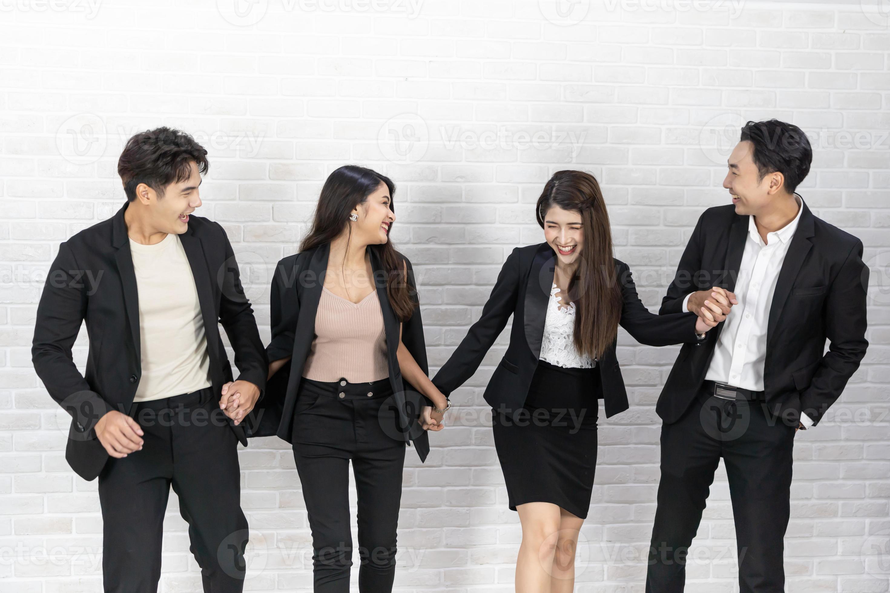 The business people standing on the white wall background. Group Of