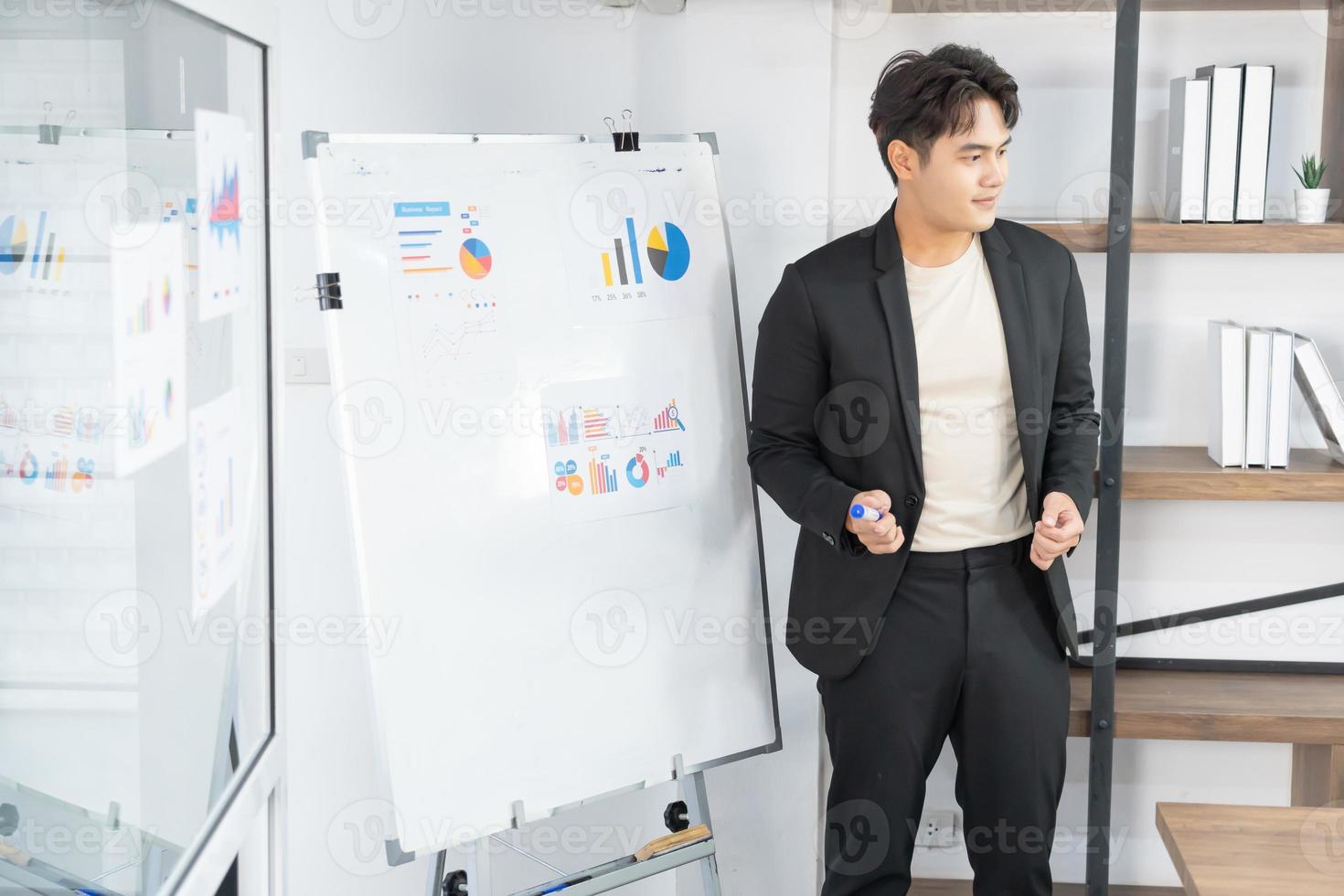 Selective Focus. Business presentation. project manager pointing at desktop presenting statistical data, briefing diverse group of employees. demonstrates statistics. photo