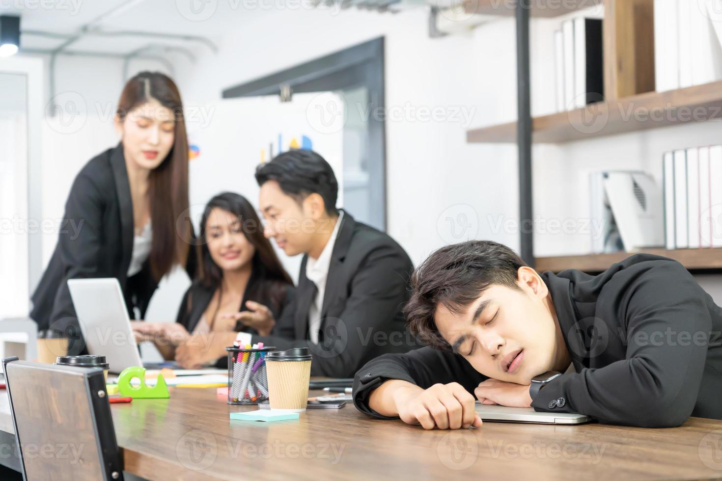 Businessman knock down on desk. overload working or deteriorating health or failure business down trend. Sleeping on the Desk at Work. photo